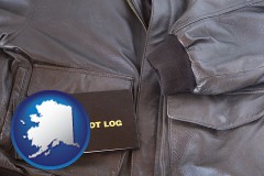 alaska map icon and an leather aviator jacket and pilot log book
