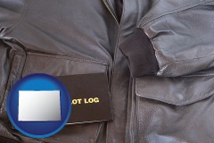 colorado map icon and an leather aviator jacket and pilot log book