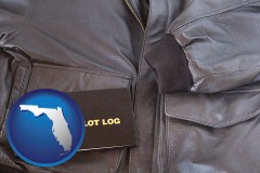 florida map icon and an leather aviator jacket and pilot log book
