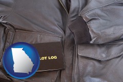 georgia map icon and an leather aviator jacket and pilot log book