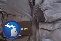 michigan map icon and an leather aviator jacket and pilot log book