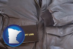 minnesota map icon and an leather aviator jacket and pilot log book