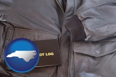 north-carolina map icon and an leather aviator jacket and pilot log book
