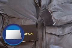 north-dakota map icon and an leather aviator jacket and pilot log book