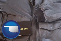 oklahoma map icon and an leather aviator jacket and pilot log book