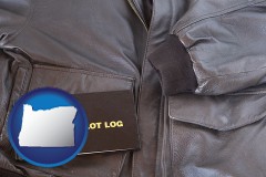 oregon map icon and an leather aviator jacket and pilot log book