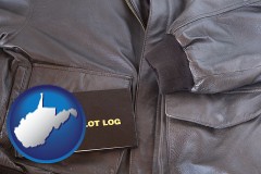 west-virginia map icon and an leather aviator jacket and pilot log book