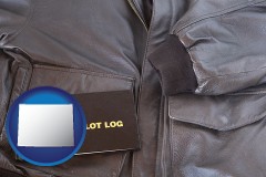 wyoming map icon and an leather aviator jacket and pilot log book