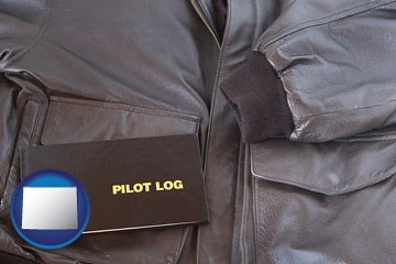 an leather aviator jacket and pilot log book - with Wyoming icon
