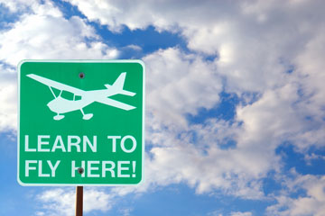 an aviation school sign advertising flying lessons